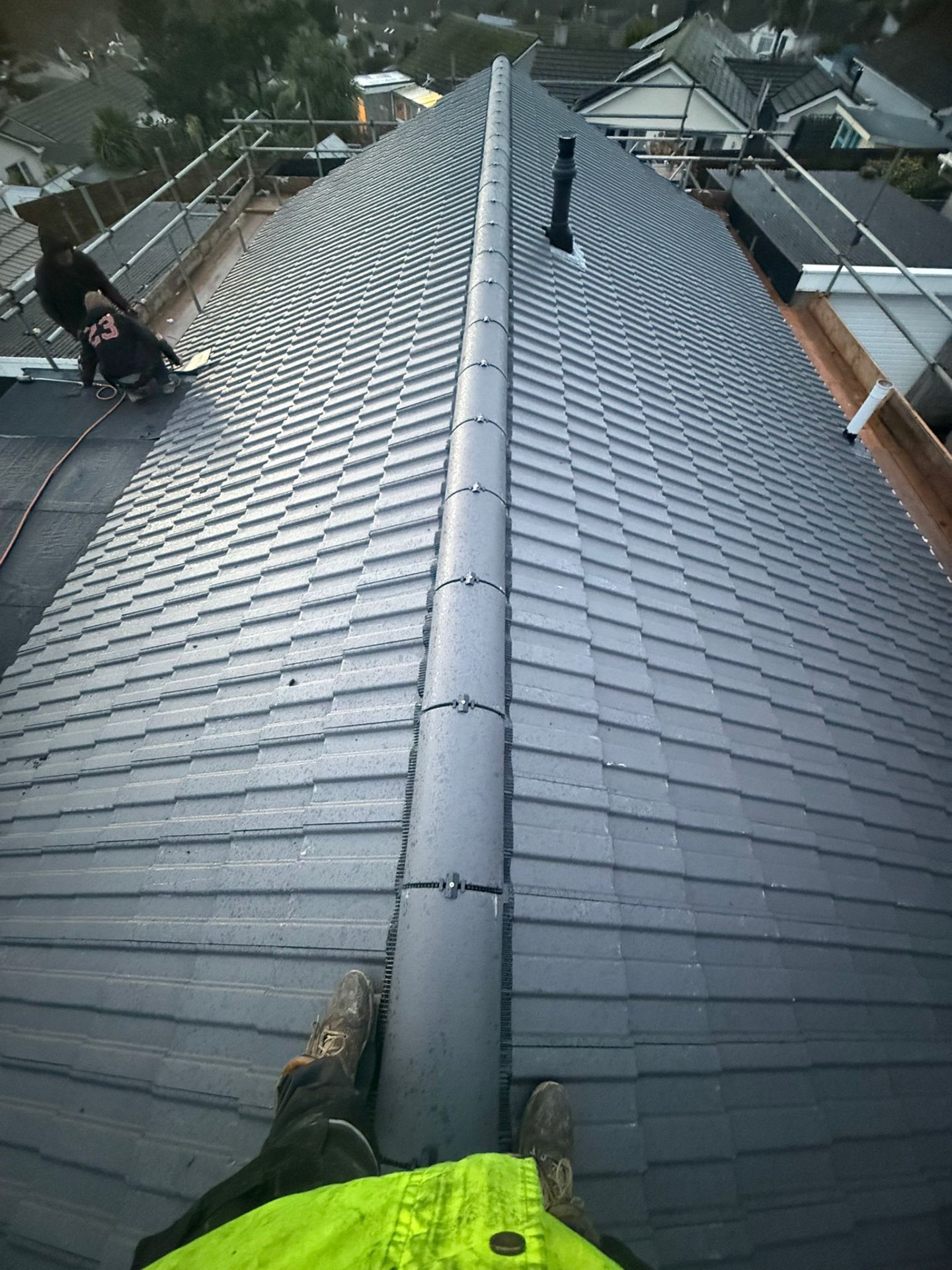 Completed concrete tile roof with new ridge tiles and dry-verge system